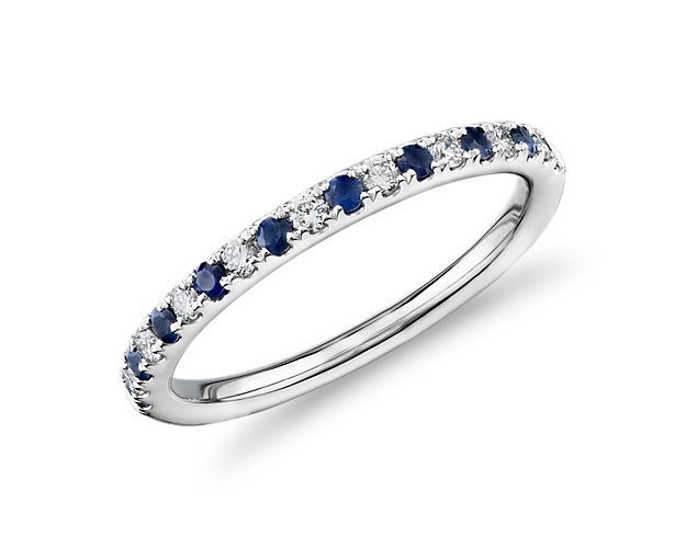 Delicate and brilliant, this platinum ring features alternating pavé set diamonds and sapphires for a classic and colorful look.