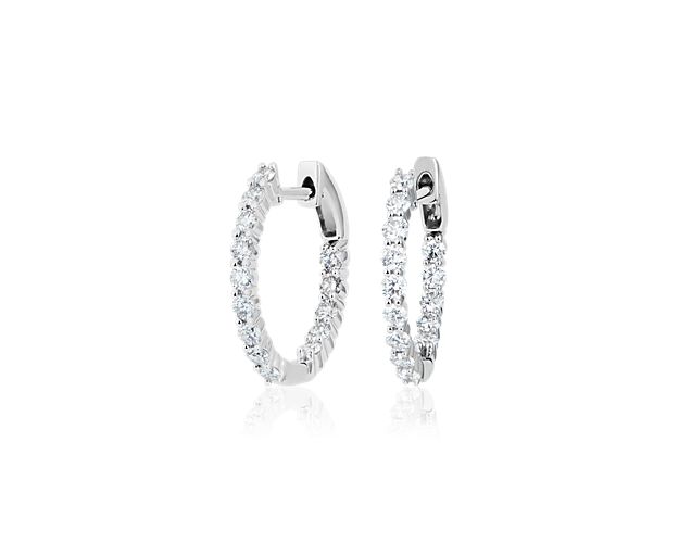 Beautifully crafted, these diamond earrings feature round diamonds set throughout each hoop earring design of 14k white gold.