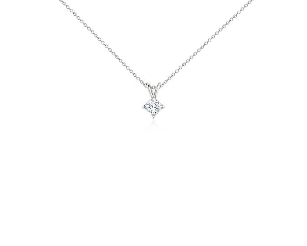 A princess-cut diamond is held by platinum prongs. A platinum bail suspends the pendant from a cable-link chain. 1/2 carat total diamond weight.