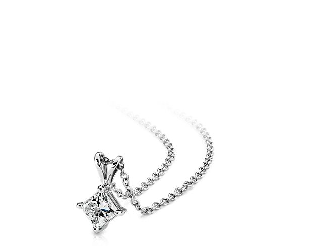 A near-colorless princess cut diamond is secured at the corners by 18k white gold prongs. An 18k white gold bail suspends the pendant from an 18k white gold cable-link chain. 1 carat total diamond weight. Accompanied by either a GIA or GCAL diamond grading report.