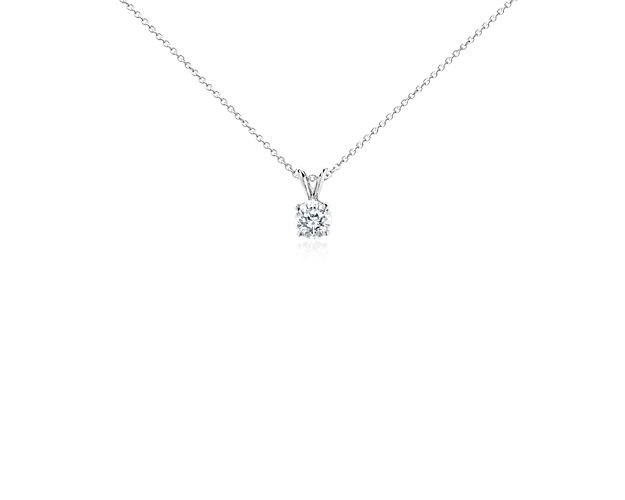 This striking pendant features a brilliant round diamond set in 18k white gold. The pendant is suspended from a delicate 18k white gold cable chain. 1 carat total diamond weight. Accompanied by either a GIA or GCAL diamond grading report.