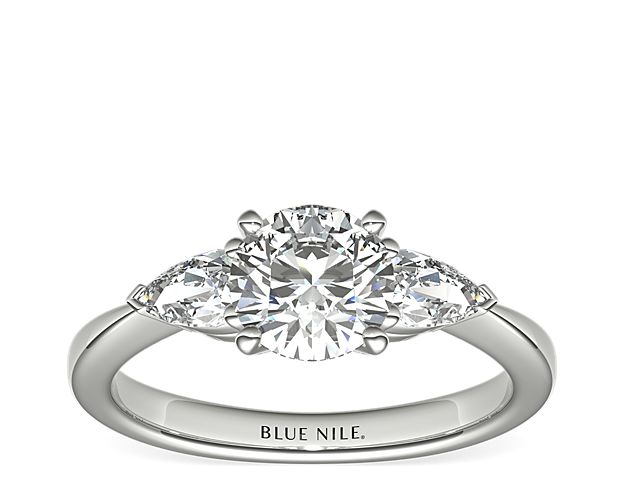 Exceptionally crafted, this diamond engagement ring showcases two beautifully matched pear-shaped diamonds prong-set in platinum to frame your center diamond. Diamonds equal 1/2 carat total weight.
