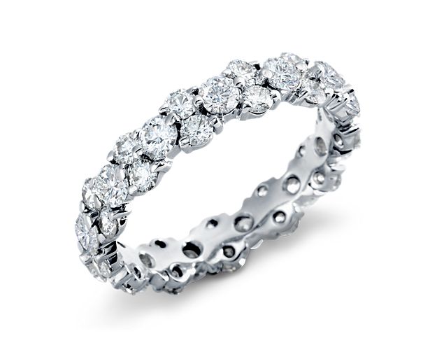 Delicate in design, elegant in form, this masterfully crafted diamond eternity ring features  brilliant round diamonds fashioned into a contemporary  garland design.  To prevent harsh damage to the exposed diamonds, we recommend wearing this ring alone.