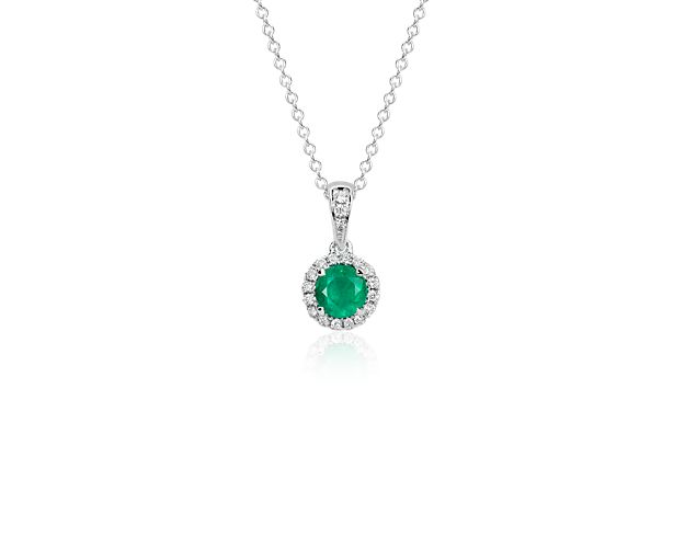 Shimmering in verdant green, this gemstone and diamond pendant features a brilliant green emerald surrounded by a halo of sparkling micropavé diamonds set in 18k white gold with a matching cable chain necklace.