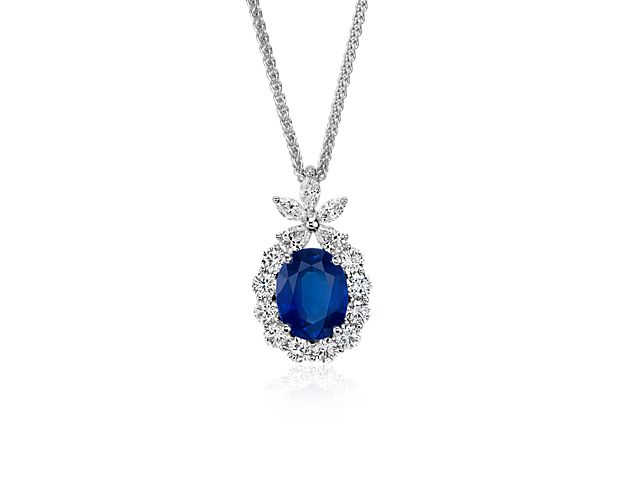 A velvety blue sapphire is set in 18k white gold surrounded by brilliant cut diamonds with marquise and pear shape diamond accents.