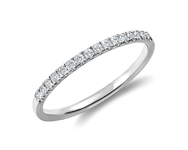 Delicately crafted, this petite pavé diamond ring is set in enduring platinum with diamonds along the top of the ring to create a fine line of brilliance.