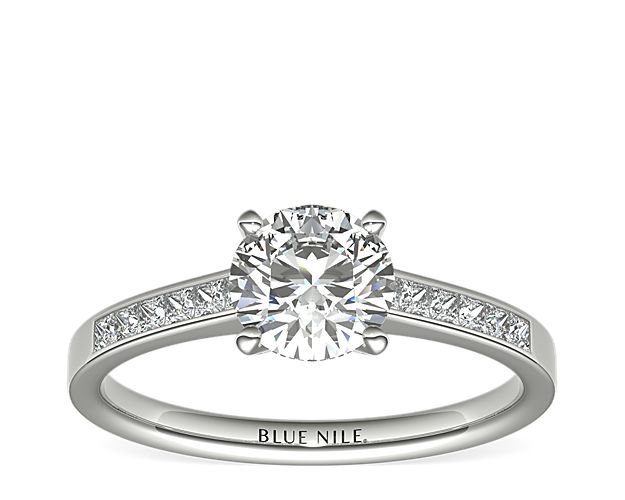 Distinctly beautiful, this diamond engagement ring showcases twelve princess-cut diamonds that are  set in a platinum channel design to accent your center diamond. Setting includes ¼ carat total diamond weight.