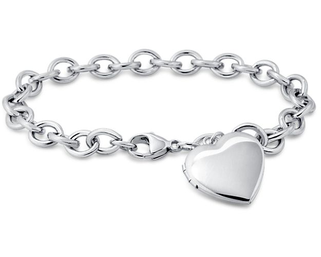 A heart-shaped locket dangles from this sterling silver bracelet. The locket opens with a snap clasp to present two of your favorite photos.