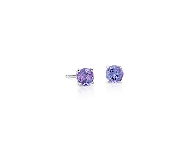 Color outside the lines with these tanzanite stud earrings. A pair of perfectly matched round tanzanites in a vivid purplish-blue shade are set in classic 18k white gold four-prong settings perfect for adding personality to your everyday attire.