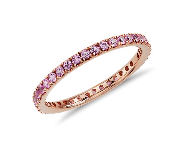 This gemstone eternity ring features a petite row of pink sapphires set in complimentary 18k rose gold.