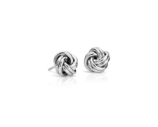 Heartfelt and feminine, these petite love knot stud earrings are intricately crafted from hollow 14k white gold links for a classic addition to any look.