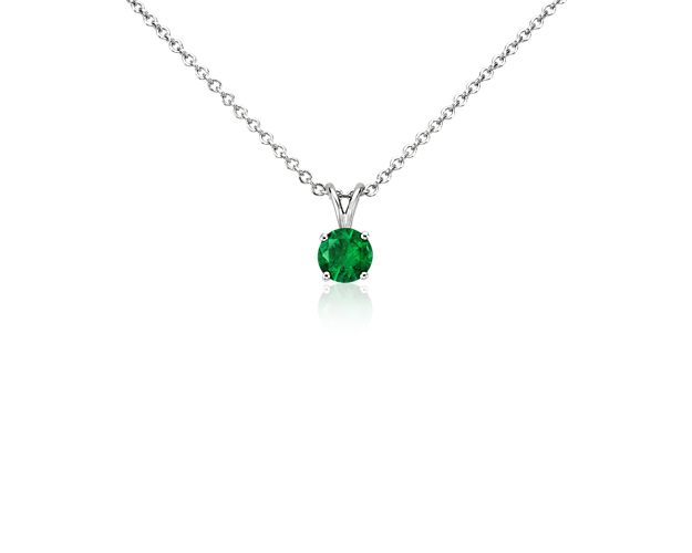A forever classic, this emerald solitaire pendant is a perfect gift for an occasion and also makes the perfect May birthstone gift. A petite, deep green emerald is framed in 18k white gold and suspended from a timeless, matching cable chain.