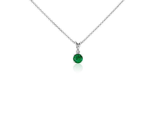 Nothing says classic color like this emerald and diamond solitaire pendant. A vibrant green emerald gemstone is accented by a single petite round brilliant-cut diamond set in bright 18k white gold with a matching cable chain. Emerald is May's birthstone and makes a beautiful gift she can wear every day.