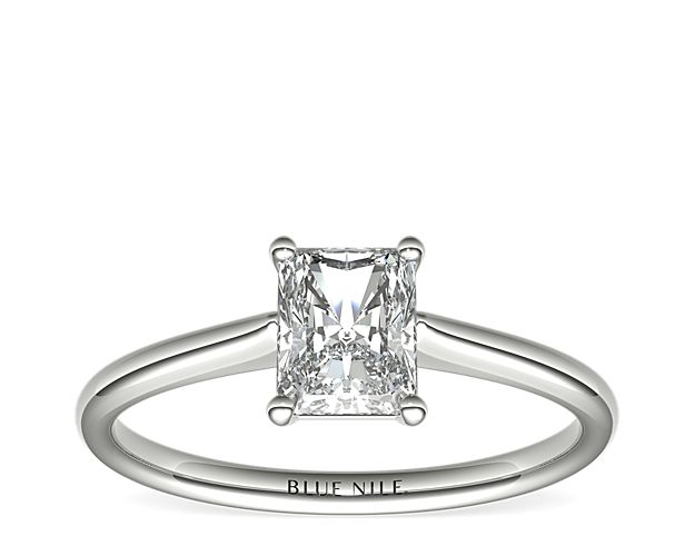 Elegant in simplicity, this petite solitaire engagement ring is crafted in polished 14k white gold to create a classic frame for your center diamond.