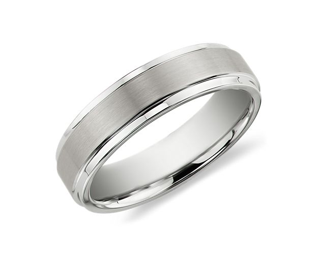 Unique in appeal, this men's wedding ring is crafted in durable tungsten carbide. The band is white in tone with a brushed finish and polished edges for contrast.