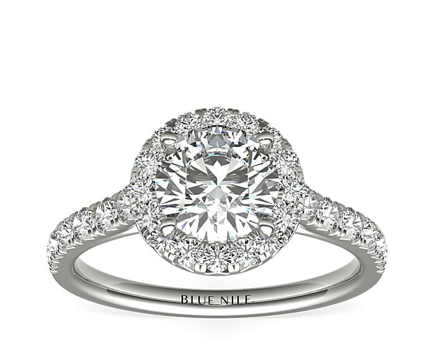 French pavé-set diamonds refers to tiny "Vs" that have been cut into the prong settings to reduce the amount of metal and to give the appearance of a continuous row of diamonds. This platinum ring, from our Blue Nile Studio, features a stunning halo to compliment the center stone of your choice.