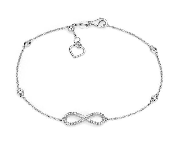 In a modern twist, a 14k white gold pavé diamond infinity sign is accented by four petite bezel-set diamonds stationed along a 14k white gold cable chain. A delicate heart accent at the clasp can be pulled to adjust the length of the bracelet.