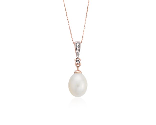 A mix of vintage style and modern simplicity, this Freshwater cultured pearl drop pendant features a lustrous white pearl accented by dainty white topaz gemstones. Set in a simple 14k rose gold frame with a matching cable chain, this pearl drop pendant also makes a beautiful bridesmaid gift.