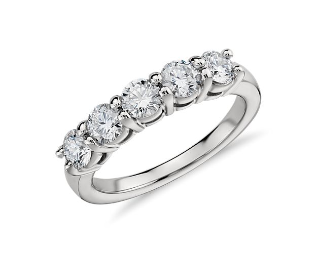 The Eternal five-stone diamond ring is just that, a timeless design that symbolizes a lasting love. Five round brilliant-cut diamonds weighing approximately 1-carat total weight sit securely in shared prongs spanning about 3/4-inch across the top of the ring. This enduring platinum five-stone ring style is an incredibly wearable essential.