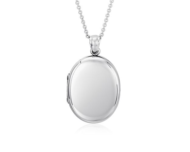 Carry your favorite memories close to your heart with this oval four-picture locket. Crafted in bright sterling silver, this substantial locket opens with a snap clasp to reveal four photos inside. The locket can  hangs from a classic sterling silver cable chain.