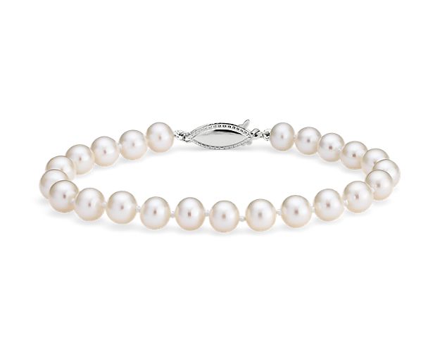 Classically luminous, this Freshwater cultured pearl bracelet features nearly-round white pearls strung on a hand-knotted 6.5" silk blend cord. A polished 14k white gold safety clasp secures the look.