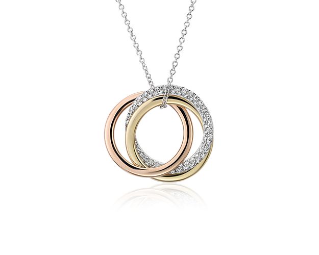 Rich in golden color, this circle diamond pendant features round diamonds pavé-set in the 14k white gold ring accented by 14k rose and yellow gold rings on a white gold necklace.