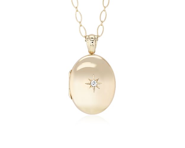 Carry loved ones close with this premium 14k yellow gold, oval locket featuring one round diamond. It opens with a snap clasp, holds two photos and is suspended from a 30-inch cable chain. This substantial locket can be engraved on the back for a personalized gift.