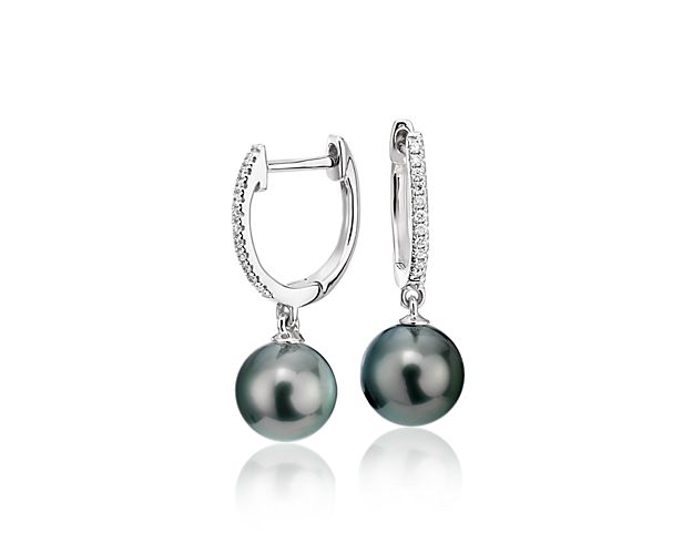 Luminous and sparkling, these Tahitian cultured pearl and diamond hoop earrings are a perfect day-to-night pair. Two round black pearls are suspended from petite, pavé diamond hoops with a hinged back closure crafted in polished 18k white gold.