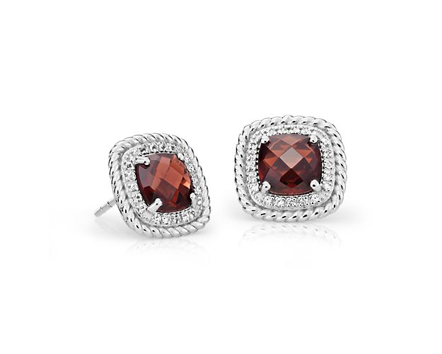 Sparkling cushion-cut garnets are surrounded by a halo of white topaz and rope detail in these sterling silver stud earrings that create big drama at an affordable price.