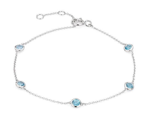 Eye-catching stations of Swiss topaz bezel-set in 14k white gold enliven this bracelet. An adjustable spring-ring clasp provides a secure, just-right fit.