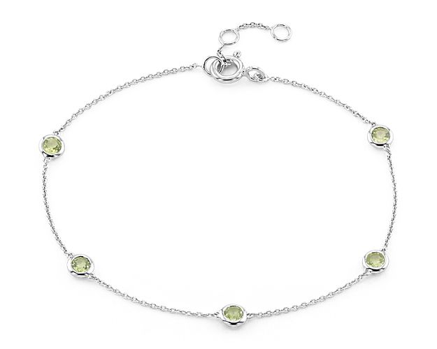 Eye-catching stations of peridot bezel-set in 14k white gold enliven this bracelet. An adjustable spring-ring clasp provides a secure, just-right fit.