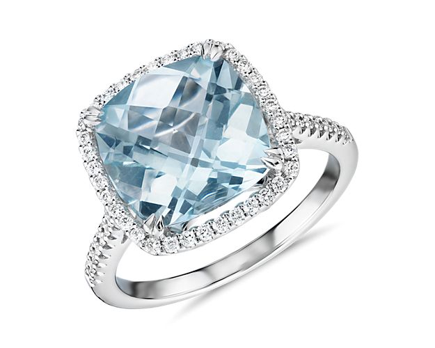 This gorgeous 14k white gold cocktail ring features a cushion-cut aquamarine surrounded by a halo of tiny pavé-set diamonds. An effortless upgrade to your accessory wardrobe.