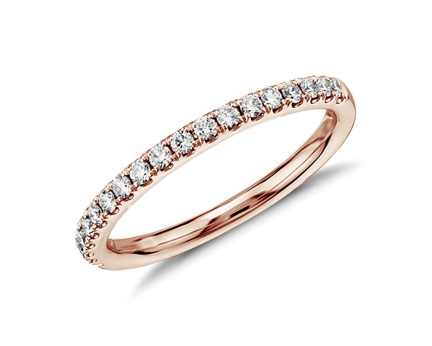 Shimmering round brilliant diamonds encircle this elegant eternity ring designed in 14K rose gold and featuring pavé-setting. A petite diamond ring ideal for a wedding band or stacked with other ring styles.