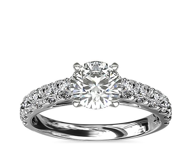 Set in stunning pavé, 1/2 ct. of sparking diamonds will radiate around your choice of center diamond.