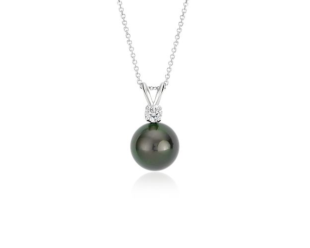 Add opulent luster to any look with this Tahitian cultured pearl and diamond pendant. A grey-black pearl solitaire is accented by a round brilliant-cut diamond set in classic 18k white gold and suspended from a matching cable chain.