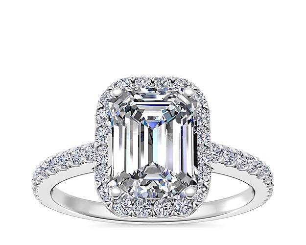Exceptionally elegant, this emerald cut halo diamond engagement ring offers a clean, modern aesthetic. The delicate 14k white gold ring features a single row of micro-pavé set round brilliant cut diamonds. Each ring perfectly frames your choice of emerald-cut center diamond.