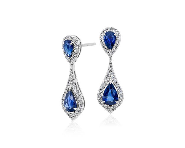 Extraordinary color is captured in these gemstone and diamond earrings, showcasing vibrant pear-shaped sapphires framed by a scintillating double halo of pavé diamonds set in 18k white gold.