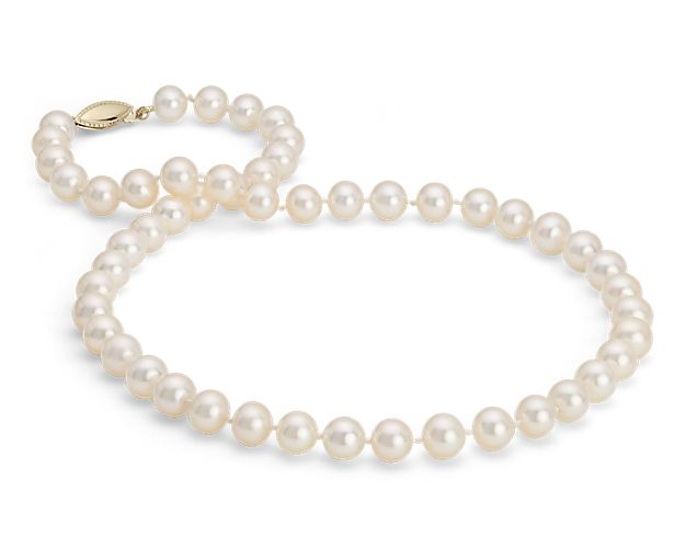 An everyday basic, this strand features nearly round freshwater cultured pearls strung on a 24" hand-knotted silk blend cord. This strand is finished with a secure safety clasp in 14k yellow gold.