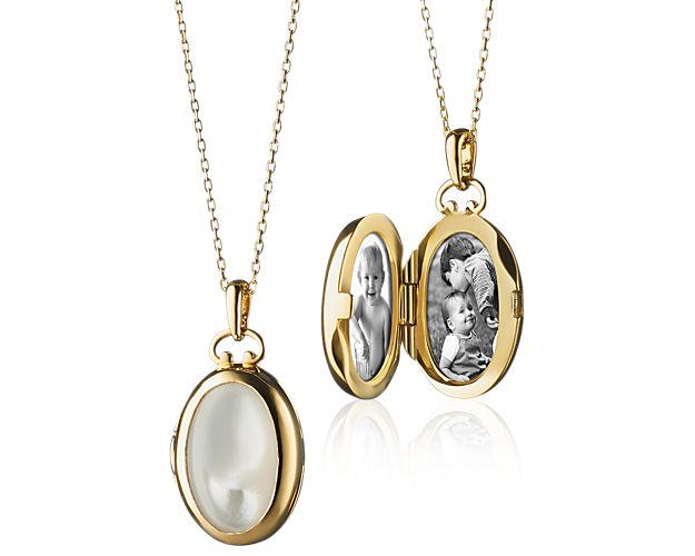 Gold locket with oval mother of pearl details.