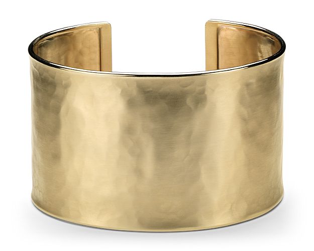 Style and shine, this Italian crafted wide cuff bracelet is forged in 14k yellow gold and features a slight hammered texture.