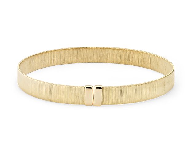 Perfect for stacking, this 18k yellow gold diamond-cut wire wrapped cuff bracelet will complete any stack.