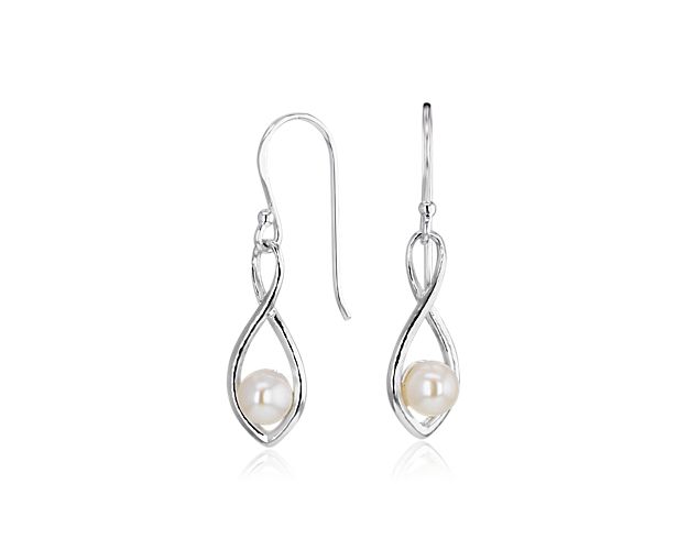 Lustrous Freshwater pearls are nestled within the swirled teardrops of these versatile sterling silver earrings.