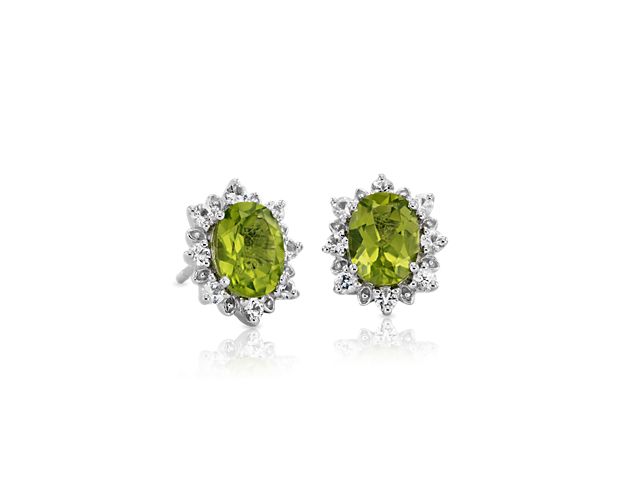The bold, oval-cut peridot surrounded by a sunburst of white topaz really dazzle in these sterling silver stud earrings.
