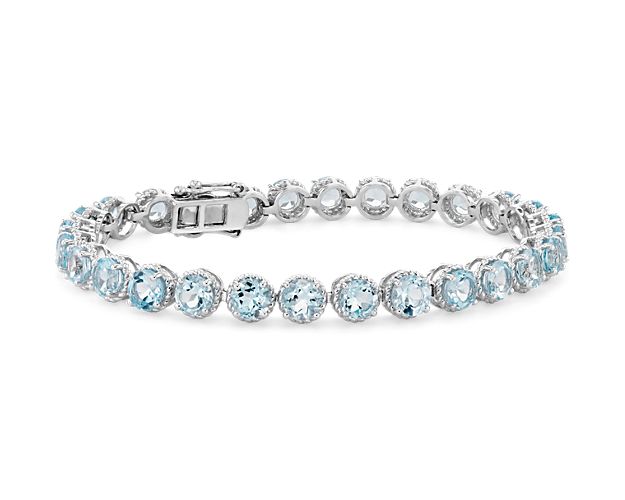 Delicately hued, this sky blue topaz bracelet is crafted in sterling silver and features twenty-eight lightly-colored, round sky blue topaz gemstones in a flexible single line design.