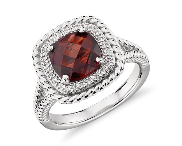 A gorgeous multi-faceted, cushion-cut garnet is surrounded by a halo of white topaz and accented with a rope motif that extends partway down the shank. This sterling silver cocktail ring is just right for a bit of color to liven up any outfit.