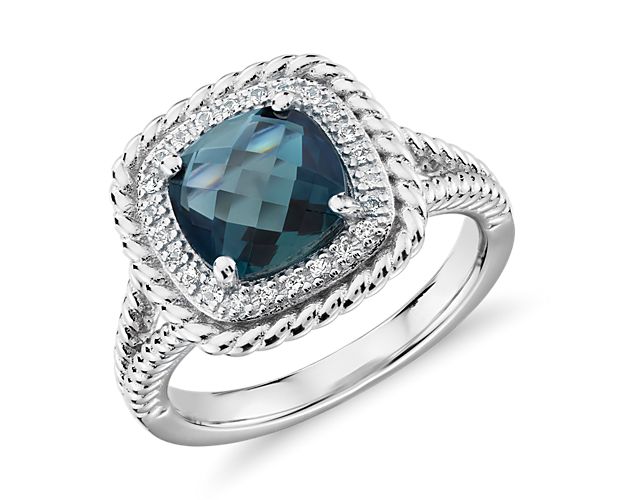 A gorgeous multi-faceted, cushion-cut London blue topaz is surrounded by a halo of white topaz and accented with a rope motif that extends partway down the shank. This sterling silver cocktail ring is just right for a bit of color to liven up any outfit.