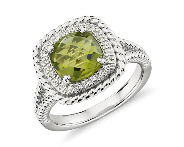 A gorgeous multi-faceted, cushion-cut peridot is surrounded by a halo of white topaz and accented with a rope motif that extends partway down the shank. This sterling silver cocktail ring is just right for a bit of color to liven up any outfit.