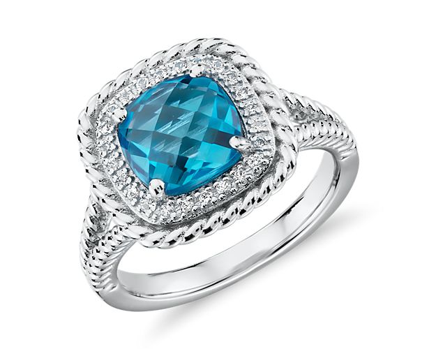 A gorgeous multi-faceted, cushion-cut Swiss blue topaz is surrounded by a halo of white topaz and accented with a rope motif that extends partway down the shank. This sterling silver cocktail ring is just right for a bit of color to liven up any outfit.