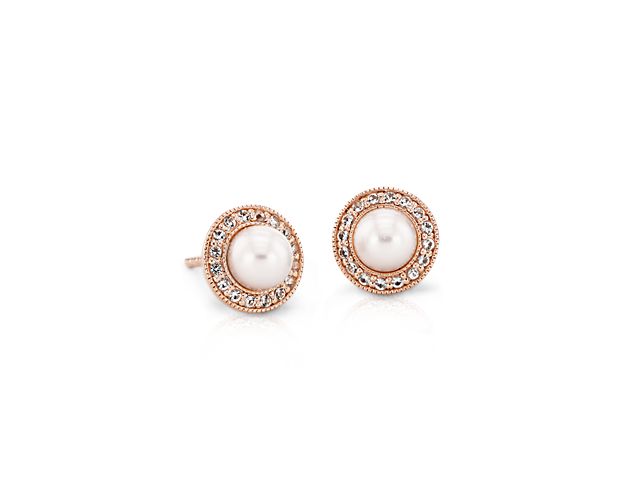 Beaming with classic charm, each of these vintage-inspired earrings feature a lustrous Freshwater pearl wreathed with elegant 14k rose gold and a crisp, bright halo of white topaz.