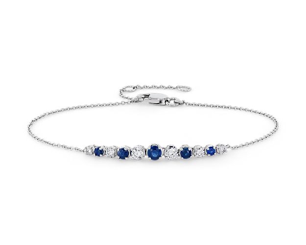 Shine day and night with these brilliant graduated prong-set sapphires and diamonds set against 14k white gold, on a delicate cable chain. For added versatility, bracelet can be adjusted in length.